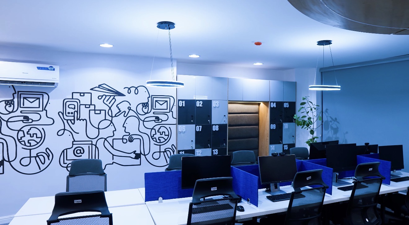 Delivered Roche Abuja work zone with blue workstation dividers, lockers and a collaboration nook.