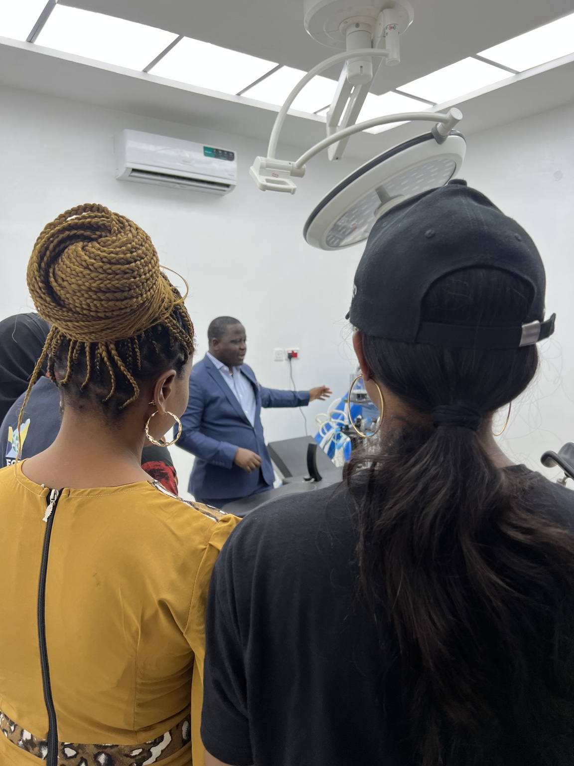 Visitors listening during a theatre walkthrough at Cardinal Care Hospital and Maternity.