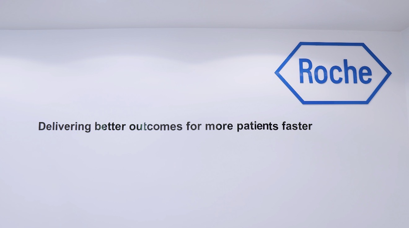 Roche identity and corporate statement installed on a white wall at the Abuja workplace.