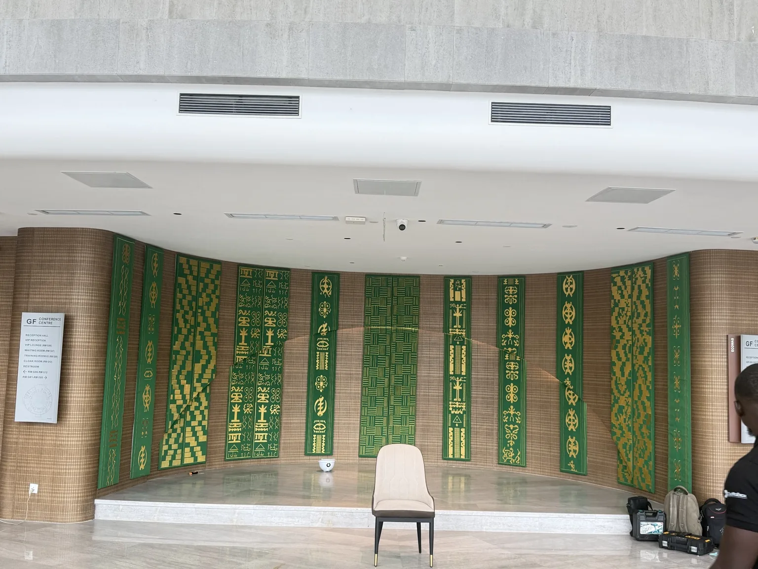 Close view of the green and gold decorative wall panels installed at the ECOWAS Commission headquarters.