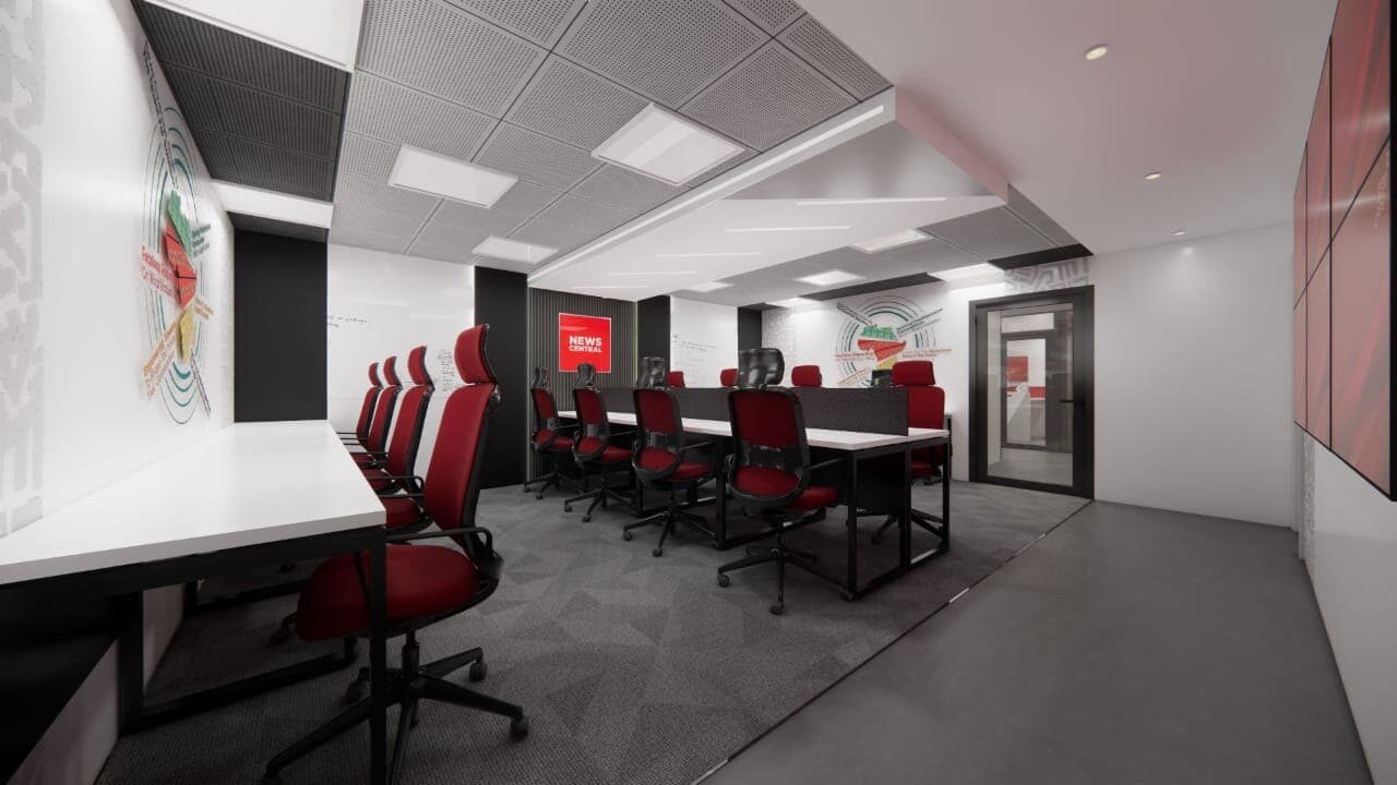 News Central Abuja workplace: boardroom with red upholstered seating, dark table and branded wall graphic.